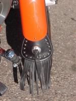 small mud flap with studs and center concho with fringe